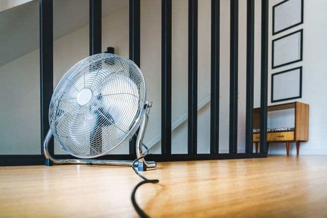 Air mover directed against a wall after water damage
